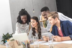 people working together looking at a laptop