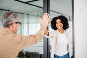 two people clapping smiling