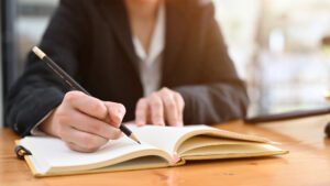 person writing in a notebook