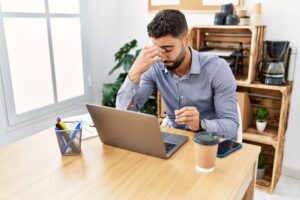 worker sitting at desk tired and alone
