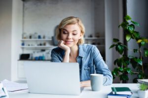 person looking at laptop at home