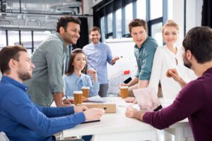 people talking and smiling in the workplace