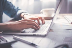 person typing on a laptop