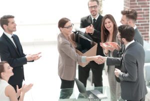 Workers congratulating and shaking hands