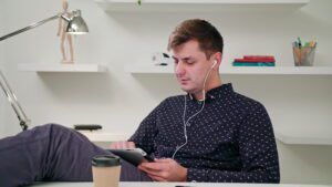 Person on ipad with headphones in