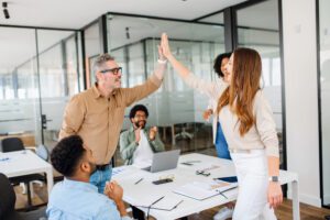 People in office highfiving