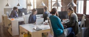 people working amongst each other in office