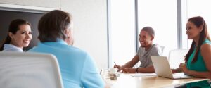people talking in office at a table