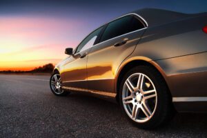 Luxury car driving into the sunset