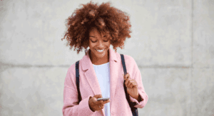 woman looking at her phone happy