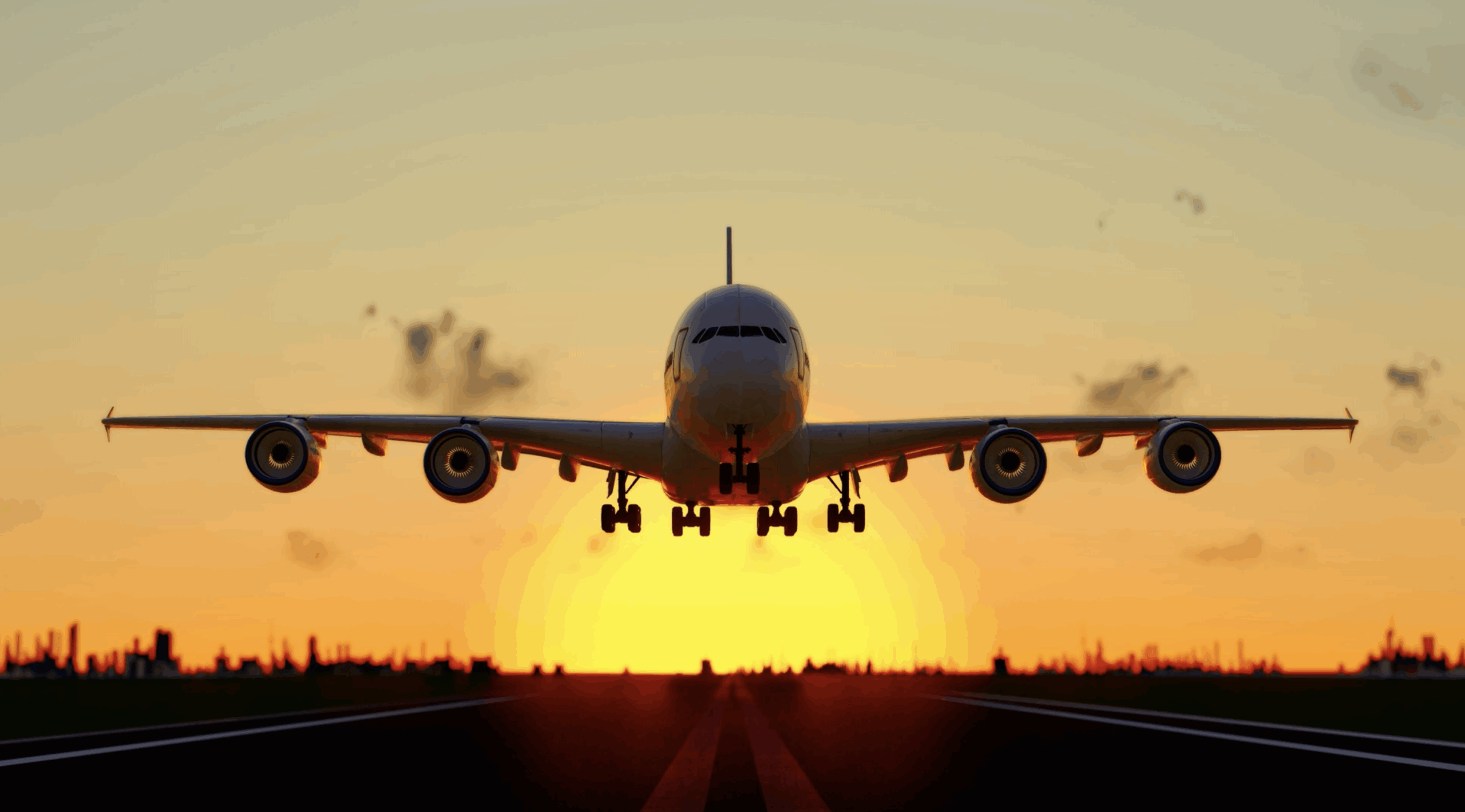 Plane taking off at sunset