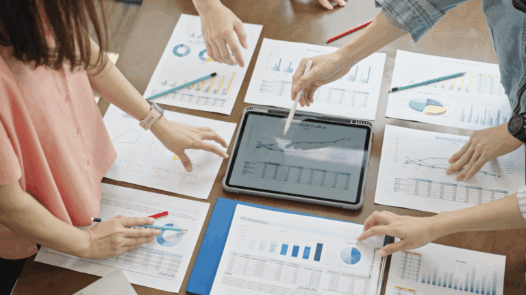 Group of employees with charts and graphs