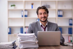 employee smiling with all of his work